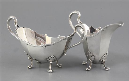 A George V Asprey & Co Ltd silver helmet shaped cream jug and boat shaped two handled sugar bowl, 16.5 oz.